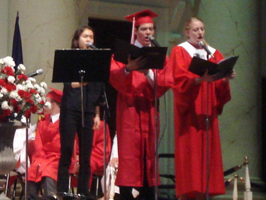 3 people in the George Mason High School choir sing a song titled "When You Believe" at graduation service